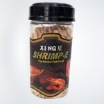 Xing Shrimp-E natural fish food in a resealable package, featuring high-quality pellets designed for shrimp and small aquatic creatures, promoting healthy growth and vibrant colors.