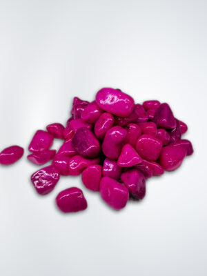 "Close-up of vibrant pink aquarium stones available at Happy Fish and Pet, a local aquarium shop in Kukatpally, showcasing their polished surfaces and suitability for enhancing aquascapes in freshwater and saltwater tanks."